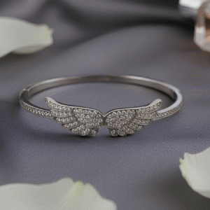 Graceful and uplifting, the Seraphine Bangle Bracelet captures the spirit of freedom and elegance. Crafted with shimmering pavé-set wings, this open bangle brings celestial charm to your wrist. A statement of lightness and strength, it’s perfect for both everyday wear and moments that call for something extraordinary