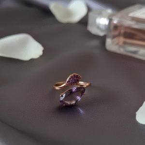 A modern open ring with a mauve teardrop zircon and dainty purple stones, finished in radiant gold.