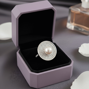 Inspired by the quiet brilliance of the ocean’s rarest jewel, Morvarid celebrates the eternal allure of pearls. Crafted in fine silver, this signature ring features a luminous central pearl set on a sculptural circular base — bold yet serene, radiant yet composed.
